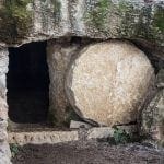 Rock-cut tomb with round stone rolled back