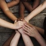 Different hues of children's hands and arms joining together: ID 96004707 © Rawpixelimages | Dreamstime.com