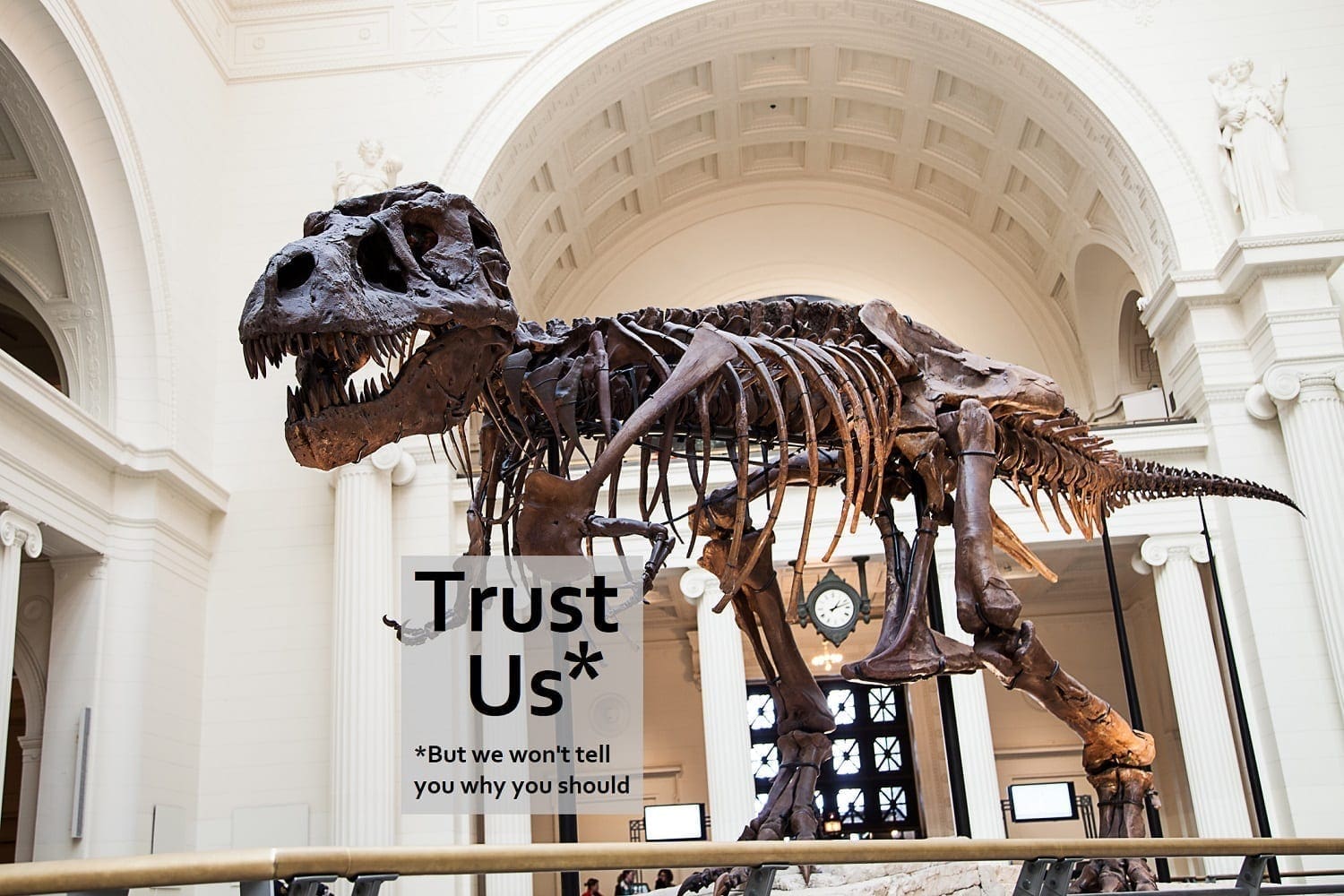Sue the T.rex holding a 'sign' saying Trust Us, but we won't tell you why you should, adapted from: ID 27396520 © Cmlndm | Dreamstime.com