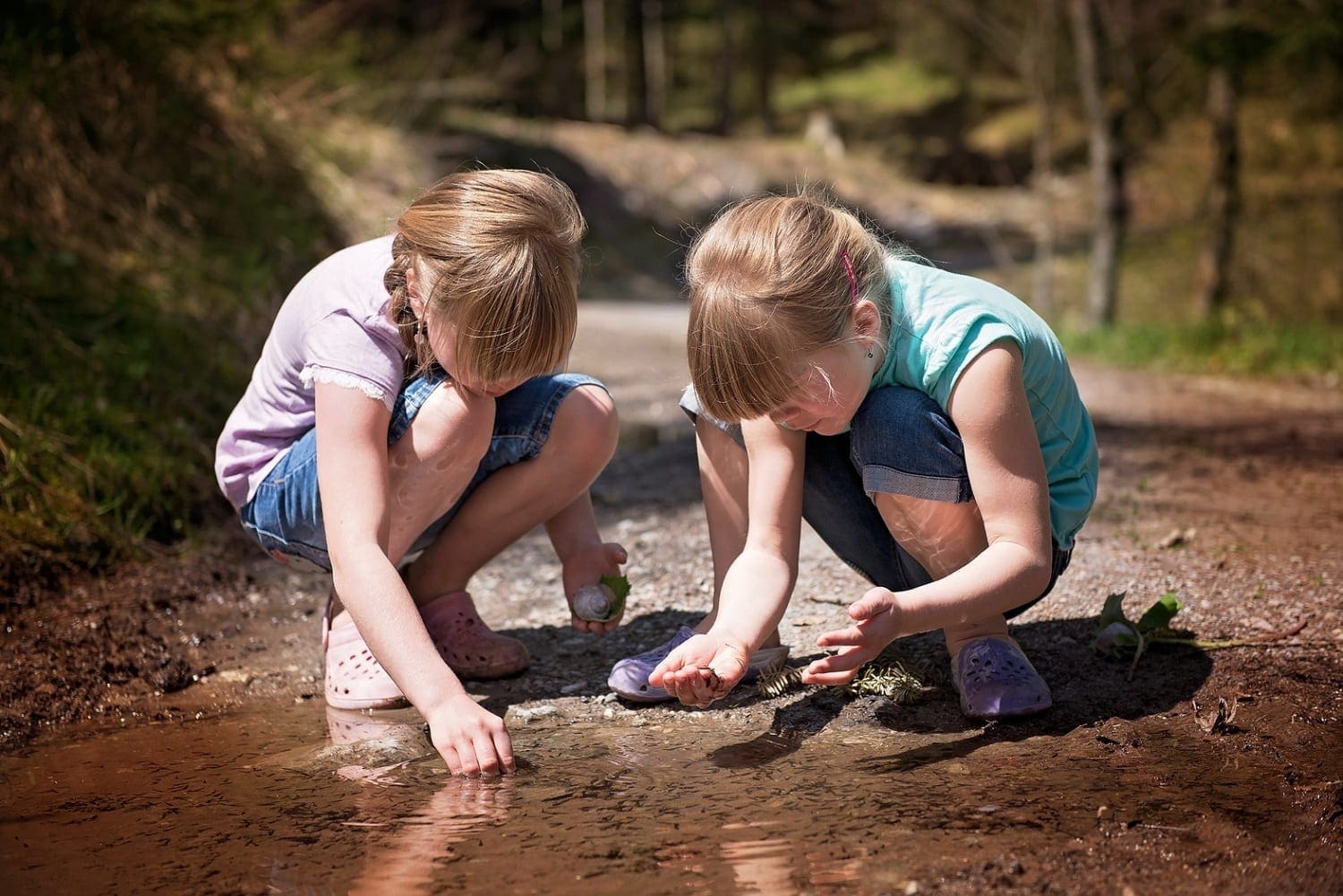 Girls playing in a mud bottomed puddle, photo credit: Pxhere
