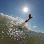 Drowning person's arm coming up out of a wave: Photo 76671162 © Mike_kiev - Dreamstime.com
