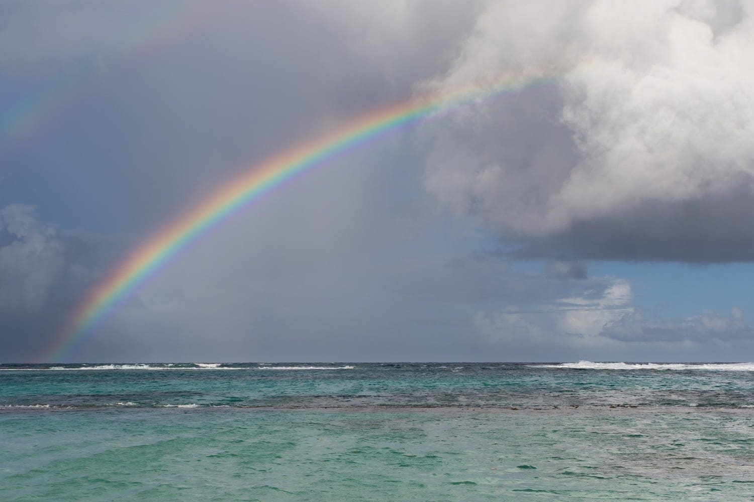 Rainbow with dark clouds over the ocean: ID 113478365 © Hopsalka | Dreamstime.com