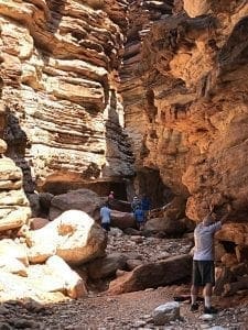 Closeup of Blacktail Canyon with visitors touching the walls, photo credit: Canyon Ministries