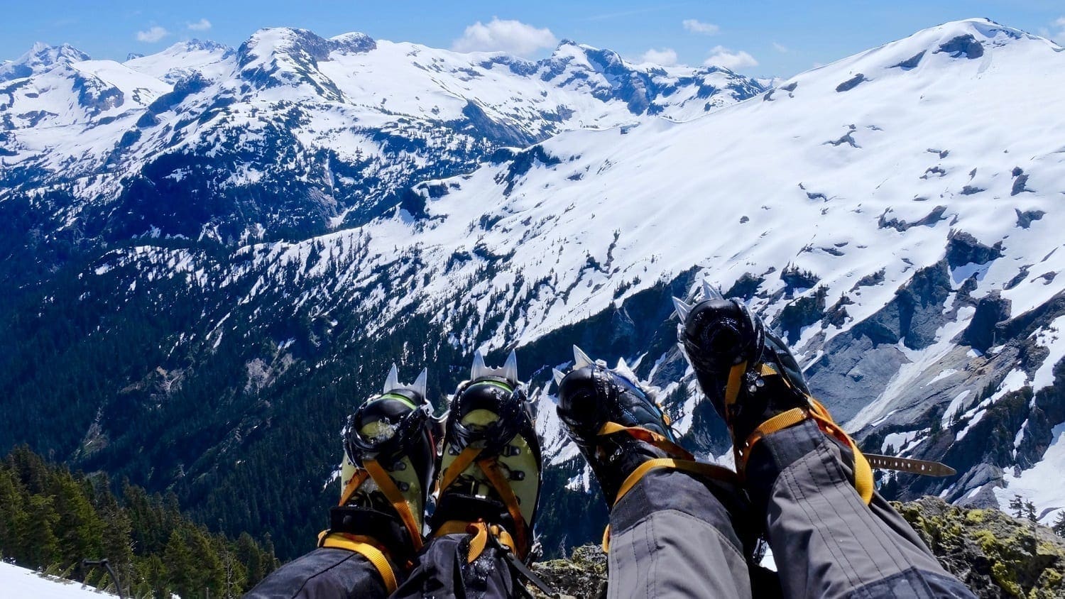 Crampone-clad feet in front of a view of snow covered North Cascade Mountains: Photo 73296343 © Aquamarine4 | Dreamstime.com