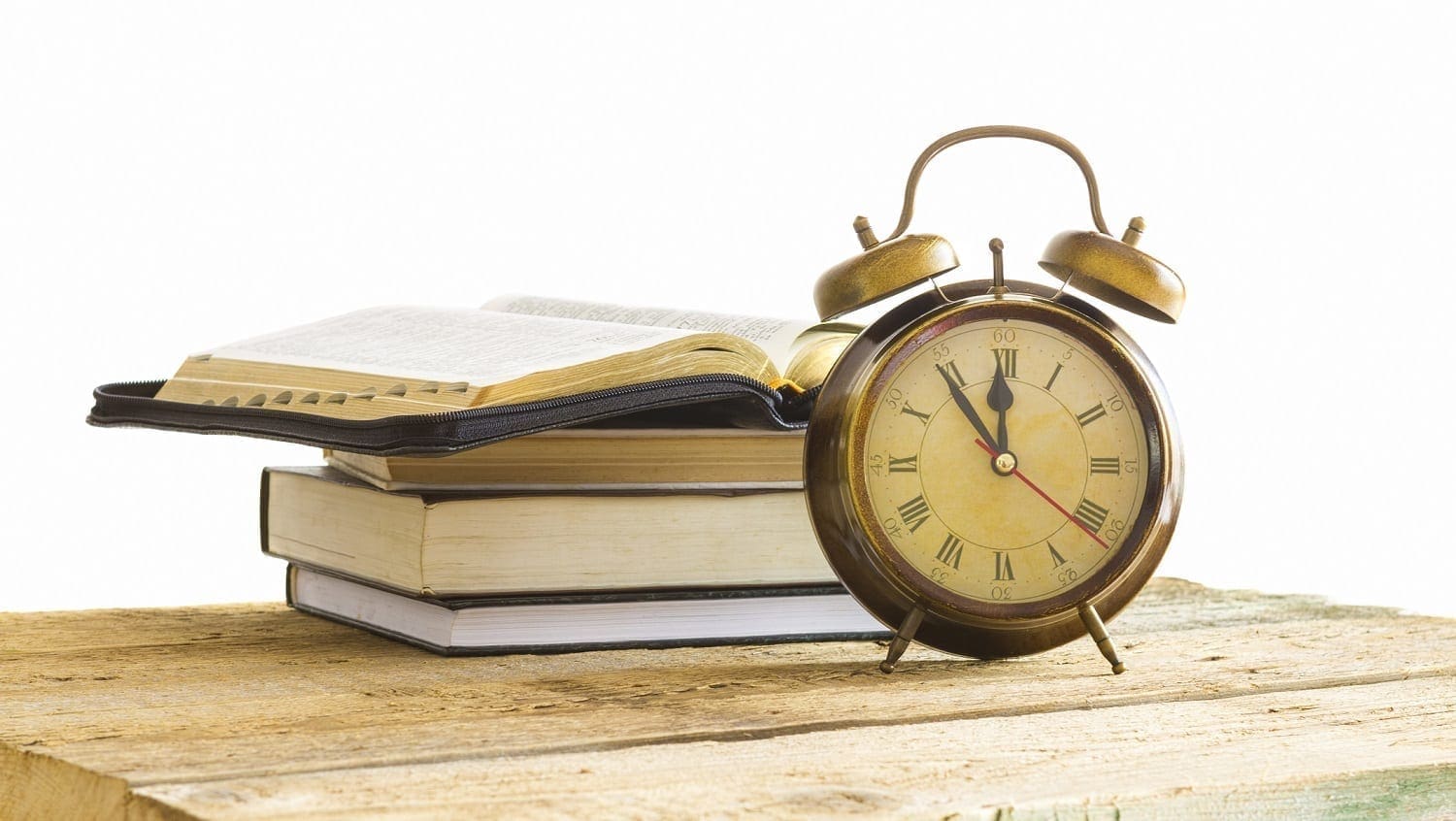 Bible on pile of books with alarm clock: ID 41050886 © Manaemedia | Dreamstime.com